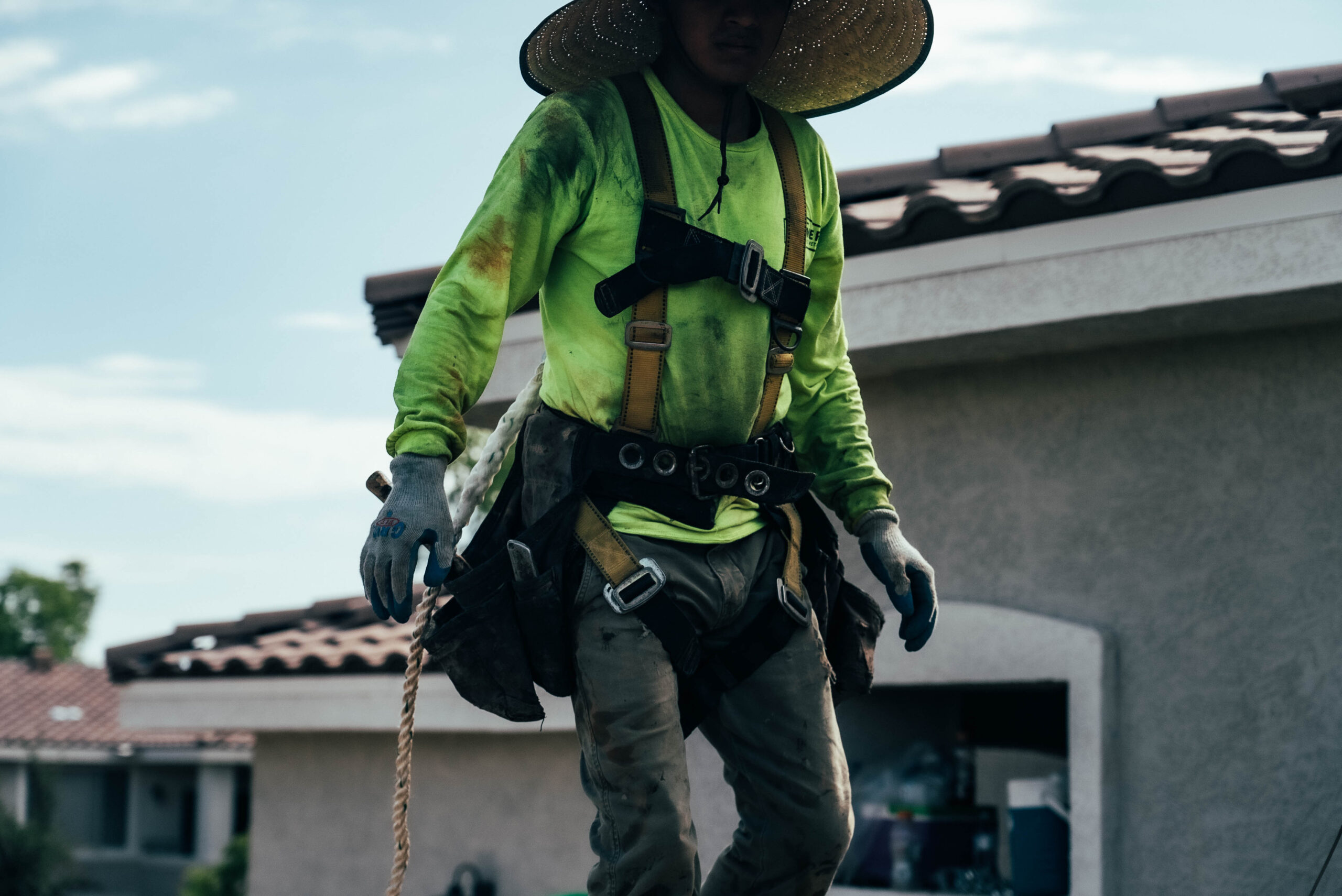 A Behmer employee on roof during tile roofing repair, a service done by Behmer in Grayhawk.