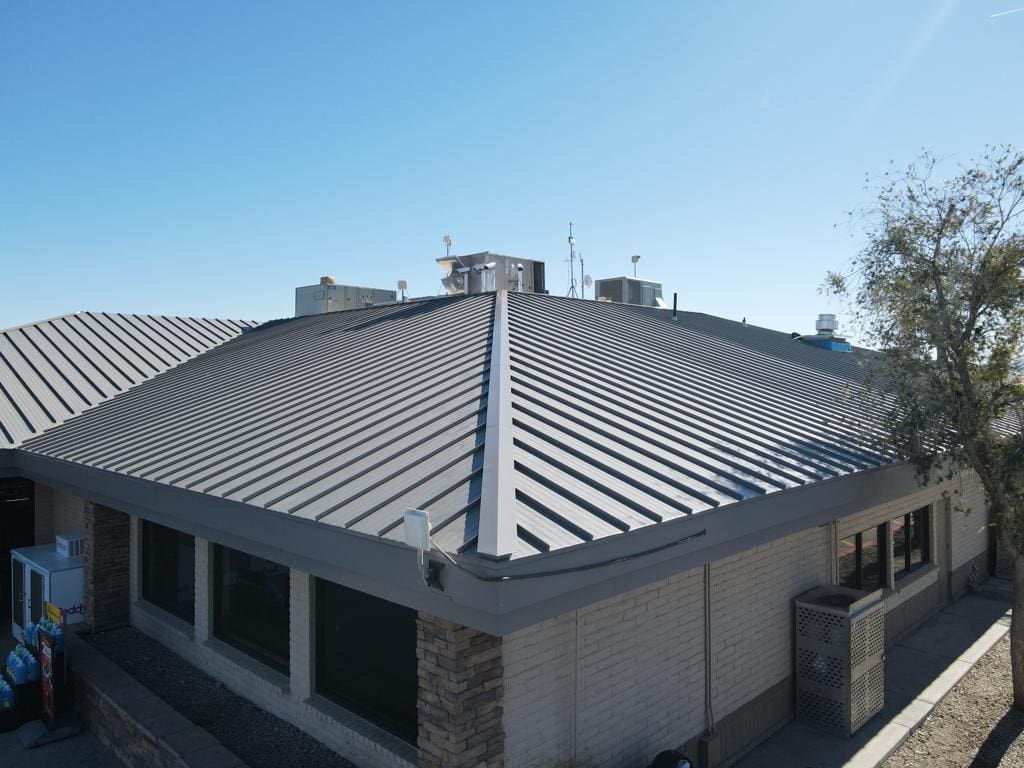 A building in Arizona with a metal roof provided by Behmer tile roofing services in Grayhawk.