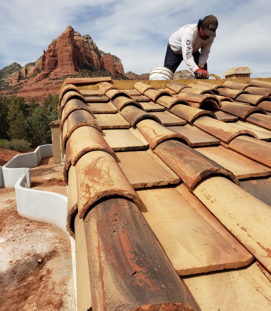 A roofer on new tile roof in AZ.