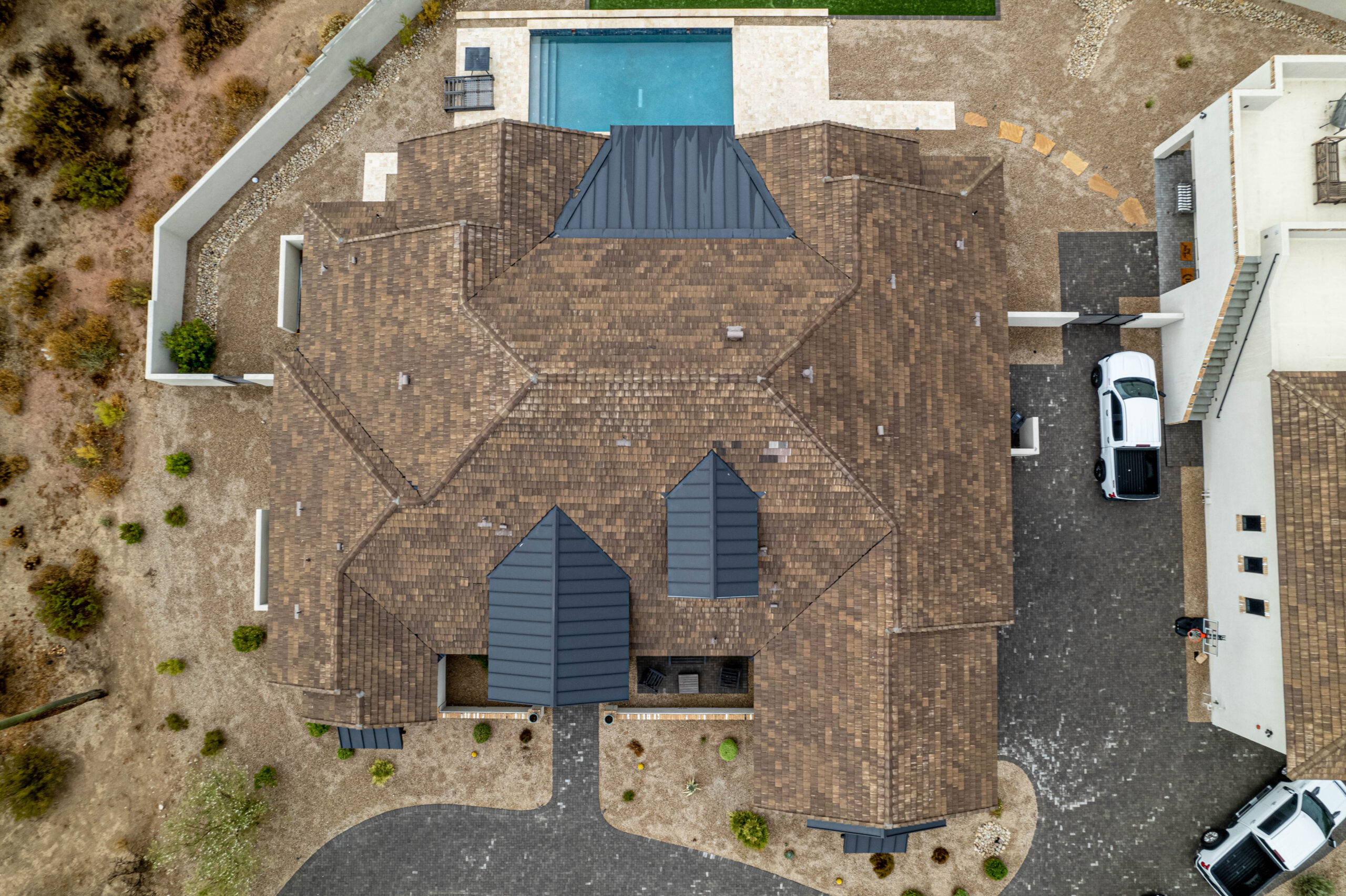 Aerial view of a Mesa neighborhood featuring a house with repaired tile roof.