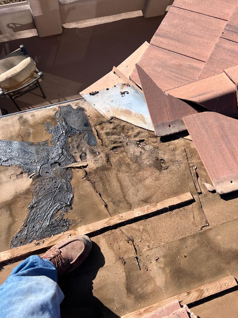 Close-up of a damaged tile on a Desert Ridge home before repair by Behmer.