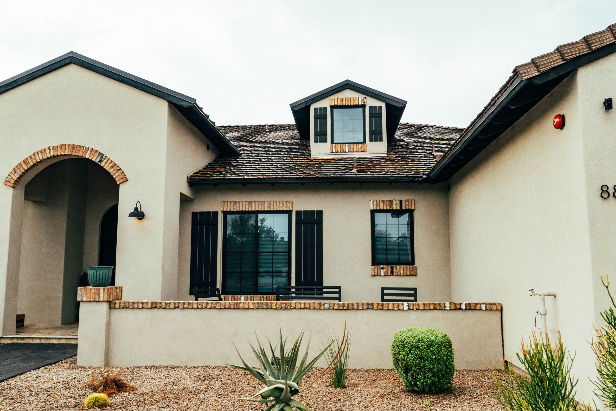 A house with a tile roof installation and a cactus in the front yard in North Phoenix.