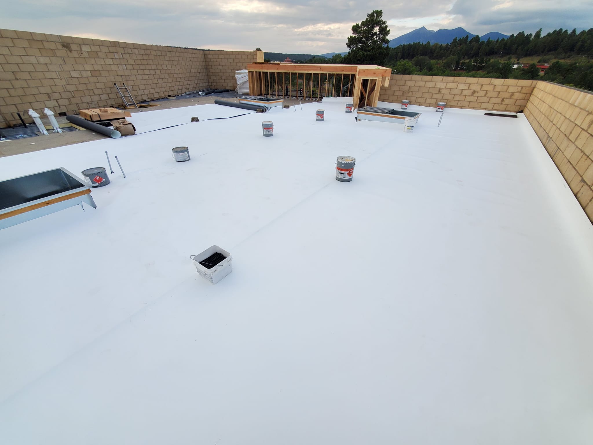 Overview of a Mesa building roof revealing completed coating sections.