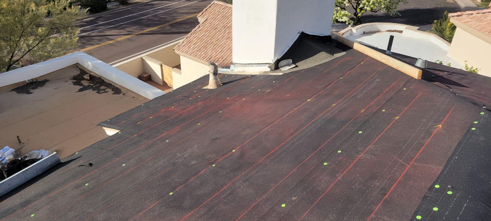 Behmer Roofing showcases their expertise in tile re-felt in Gilbert with underlayment perfectly laid out before tile placement