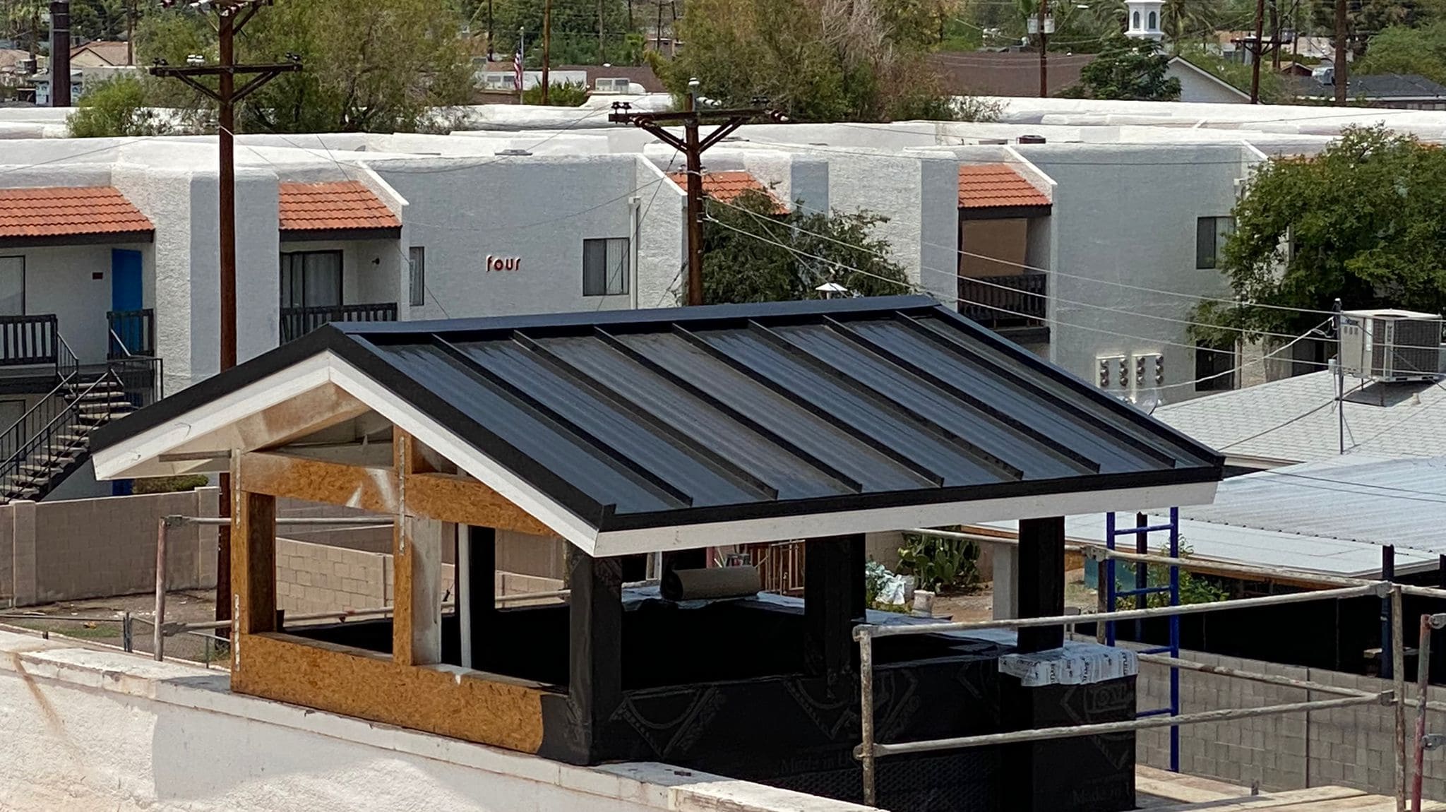 Birds-eye view of a Biltmore neighborhood, metal roofs gleaming under the Arizona sun.