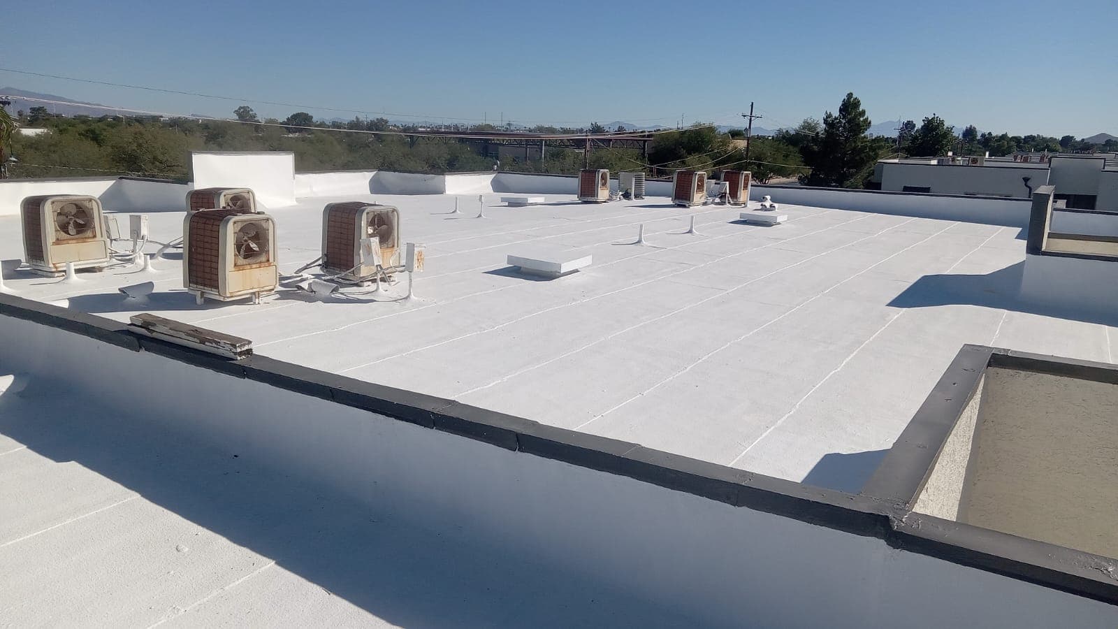 A panoramic view of a Chandler flat roof awaiting Behmer's touch, the foam surface primed for recoating.