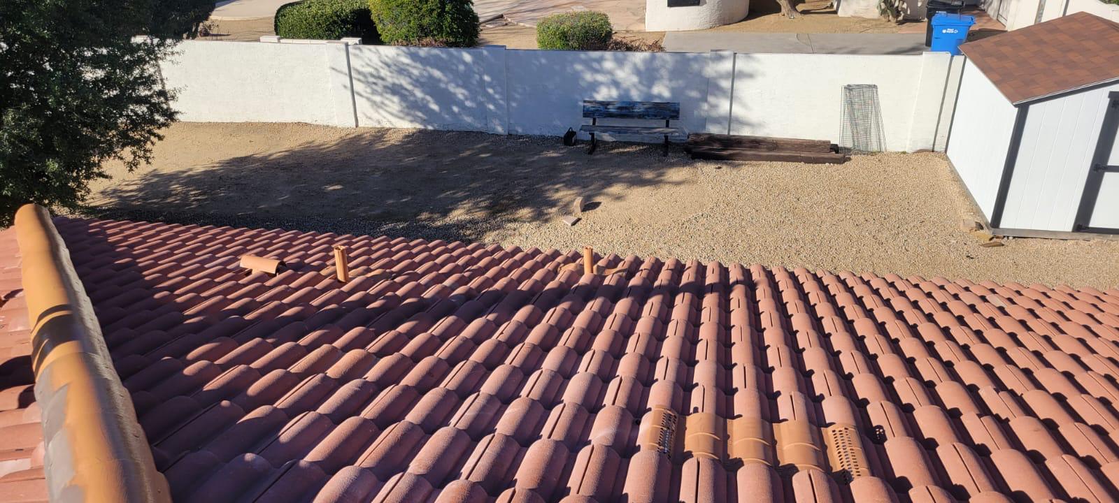 Behmer roofer aligning tiles with expertise for a re-felt project in the Estancia neighborhood.