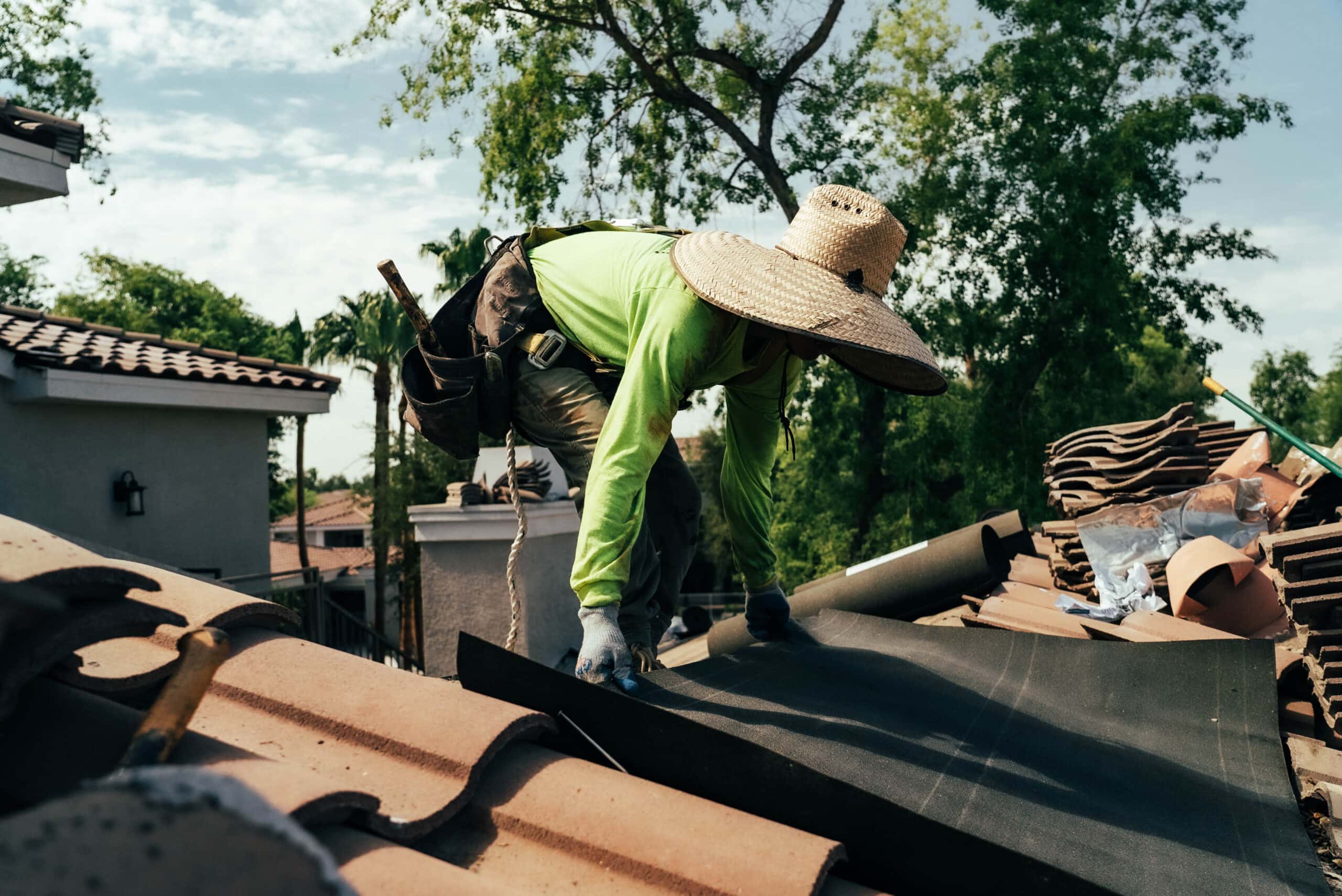 Expert roofer from Behmer ensures proper underlayment on an Estancia home during tile re-felting.