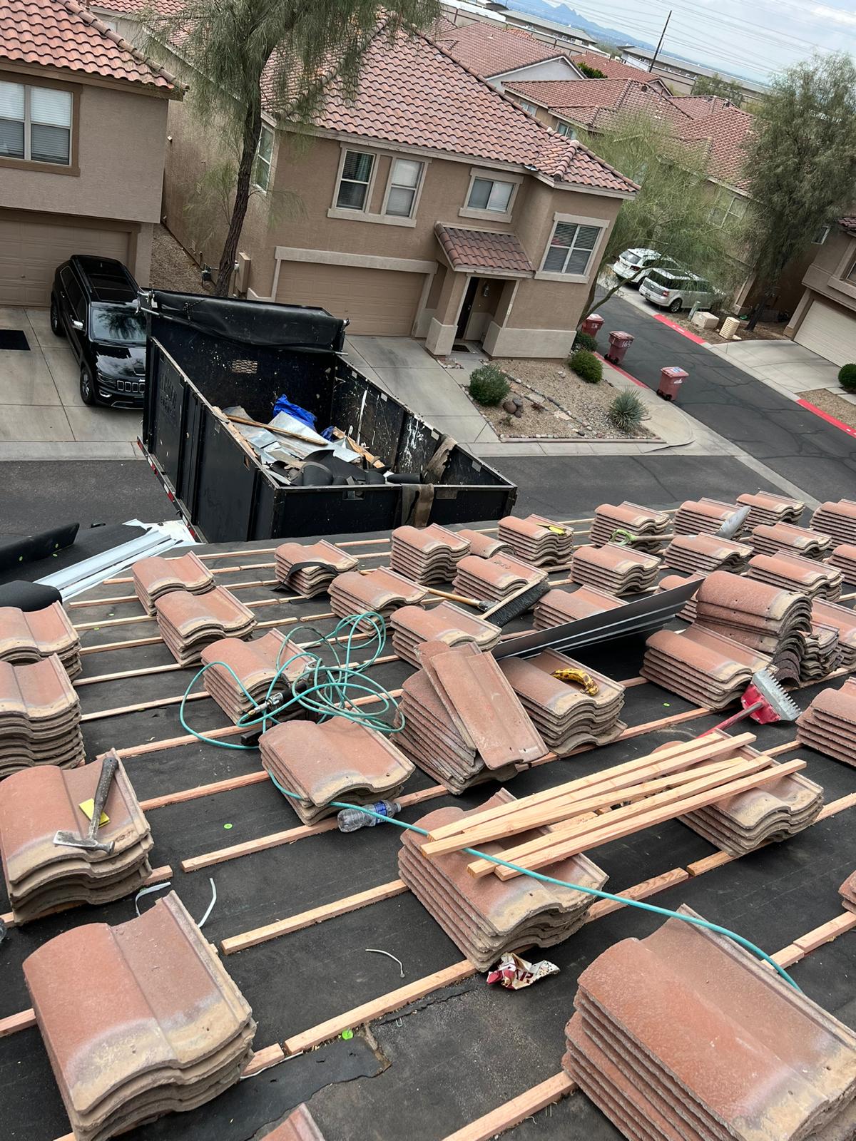 Organized stacks of tiles ready for re-felting by Behmer Roofing in Silverleaf, Scottsdale.